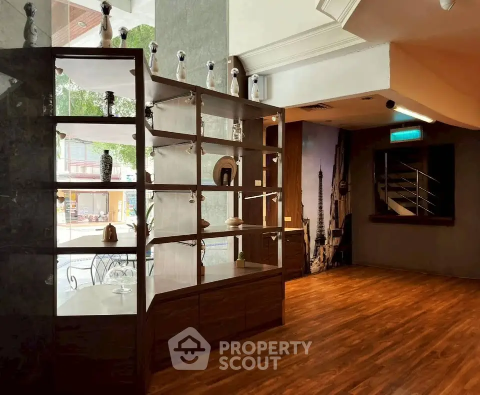 Elegant interior with wooden flooring and decorative shelving in a modern living space.