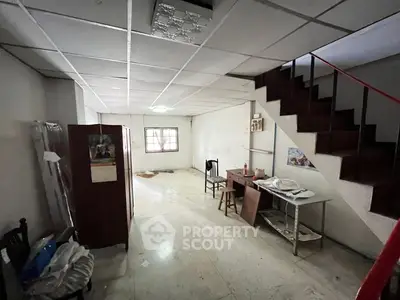 Spacious interior with staircase, ideal for renovation projects.