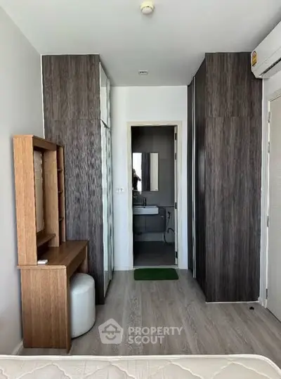 Modern bedroom with ensuite bathroom and stylish wood paneling