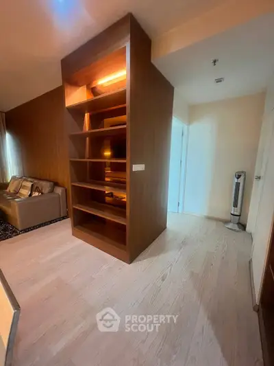 Spacious living room with built-in wooden shelves and modern decor