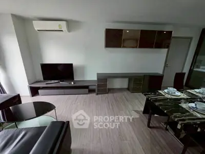 Modern living room with sleek furniture and dining area, featuring air conditioning and stylish decor.