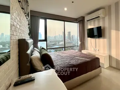 Modern bedroom with city view, featuring stylish decor and large windows for natural light.