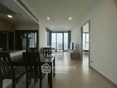 Spacious modern living room with city view, open layout, and elegant dining area.
