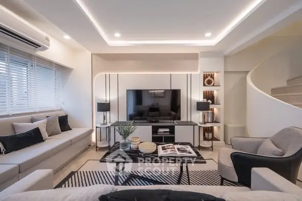 Modern living room with sleek design, featuring a large TV, stylish furniture, and ambient lighting.