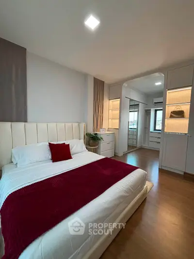 Luxurious bedroom with elegant decor and spacious walk-in closet, perfect for modern living.