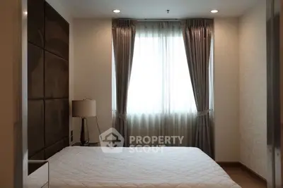 Cozy bedroom with elegant curtains and soft lighting