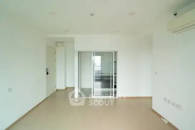 Spacious minimalist living room with sliding glass doors and air conditioning