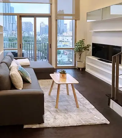 Modern living room with city view, stylish furniture, and natural light.