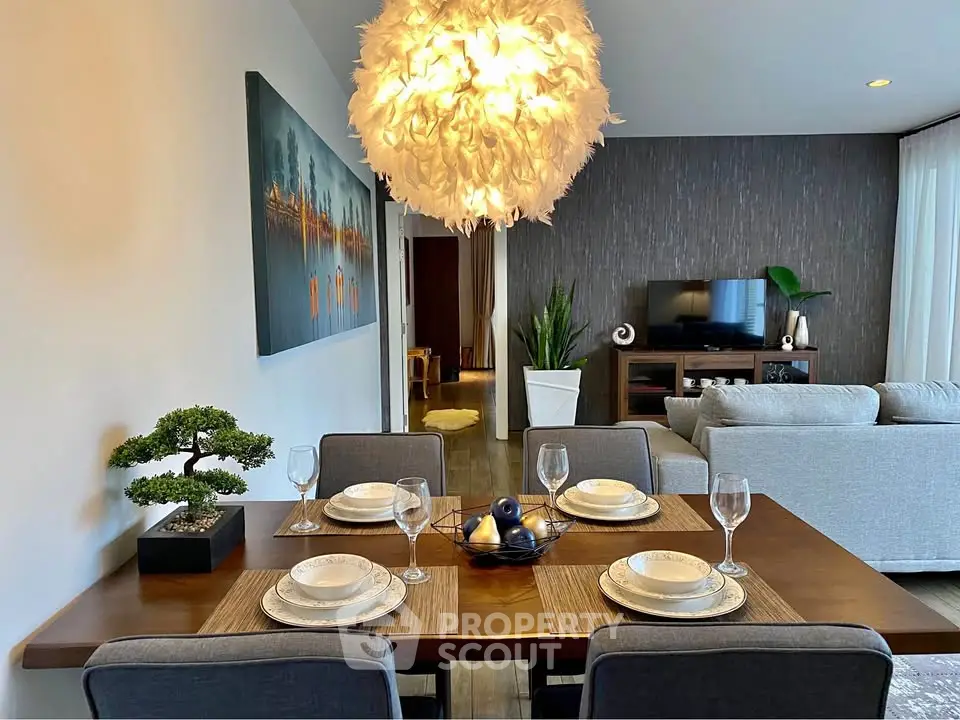 Elegant dining and living area with modern decor and stylish lighting