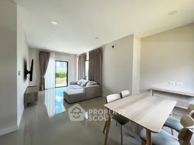 Spacious modern living room with elegant dining area and natural light