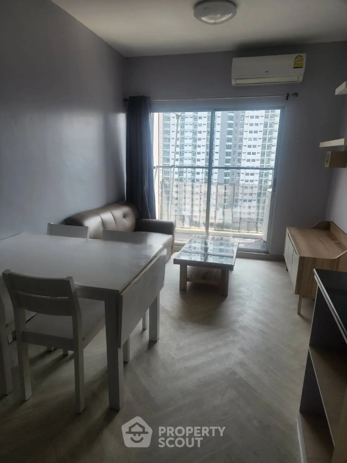 Modern living room with balcony view in high-rise apartment