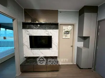 Modern living room with stylish TV wall unit and sleek storage cabinets