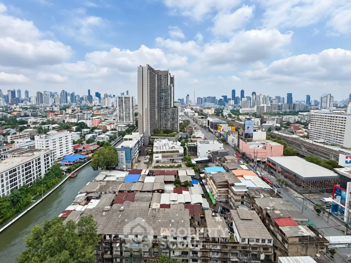 Stunning cityscape view with high-rise buildings and canal, perfect for urban living enthusiasts.