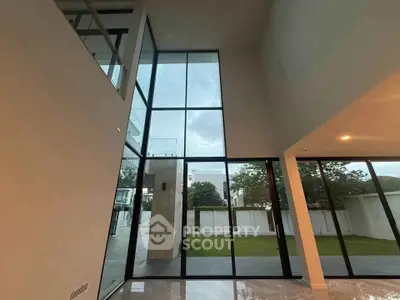 Stunning modern living room with floor-to-ceiling windows and garden view