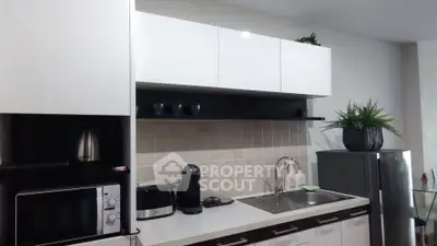 Modern kitchen with sleek cabinetry and stainless steel appliances