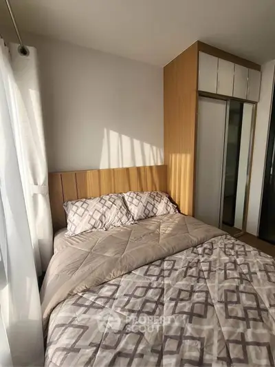 Cozy bedroom with natural light and modern wooden wardrobe