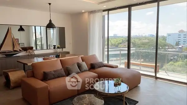 Spacious modern living room with large windows and scenic view