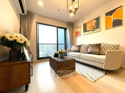 Stylish living room with modern decor and large window offering natural light.
