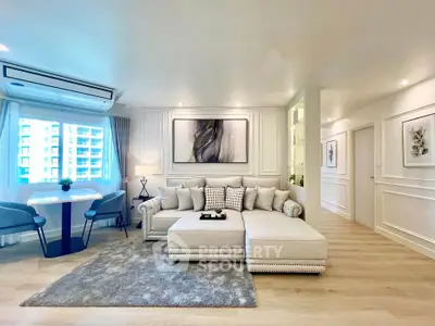 Luxurious modern living room with elegant decor and ample natural light.