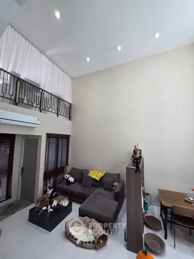 Spacious living room with high ceiling and modern decor