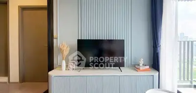 Modern living room with stylish TV setup and balcony view