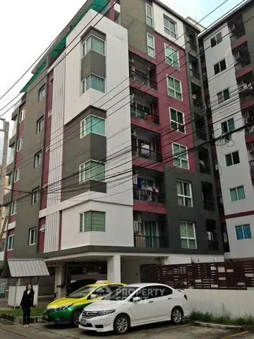 Modern apartment building with parking area and urban surroundings
