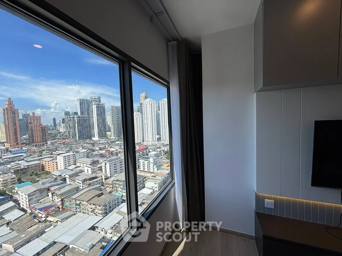 Stunning city view from modern high-rise apartment window, showcasing urban skyline and vibrant cityscape.
