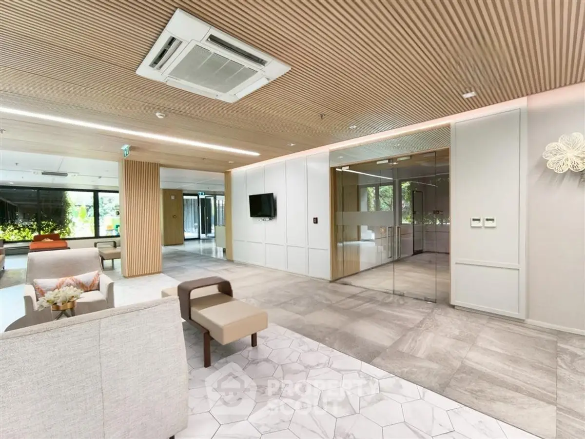 Modern office lobby with stylish seating and glass meeting room