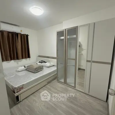 Modern bedroom with sleek wardrobe and cozy bed in minimalist design