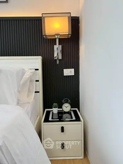 Modern bedroom corner with stylish lamp and bedside table