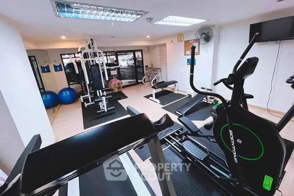 Modern gym with fitness equipment in a well-lit space, ideal for active lifestyle enthusiasts.