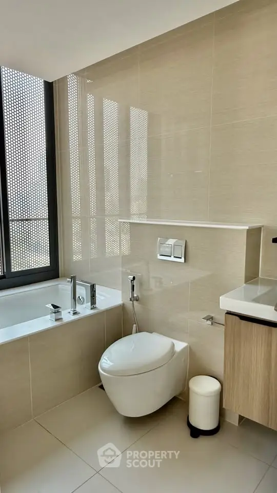 Modern bathroom with sleek fixtures and large window for natural light.
