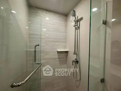 Modern bathroom shower with sleek glass enclosure and elegant tile design