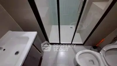 Modern bathroom with sleek shower and contemporary fixtures.