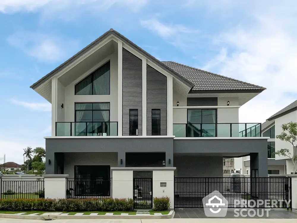 Modern two-story house with sleek design and spacious balcony in a serene neighborhood.