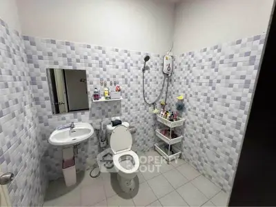 Modern bathroom with tiled walls and essential fixtures