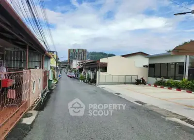Charming residential street with diverse architecture and lush greenery, perfect for serene living.