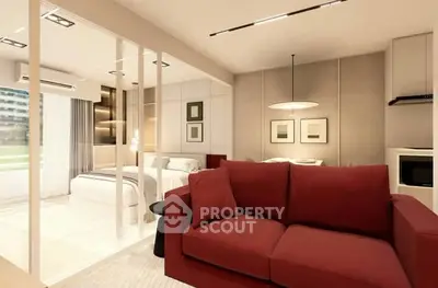 Modern living room with red sofa and open layout to bedroom, featuring stylish decor and ample natural light.