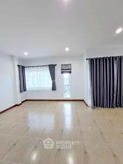 Spacious empty living room with large windows and elegant curtains, perfect for customization.
