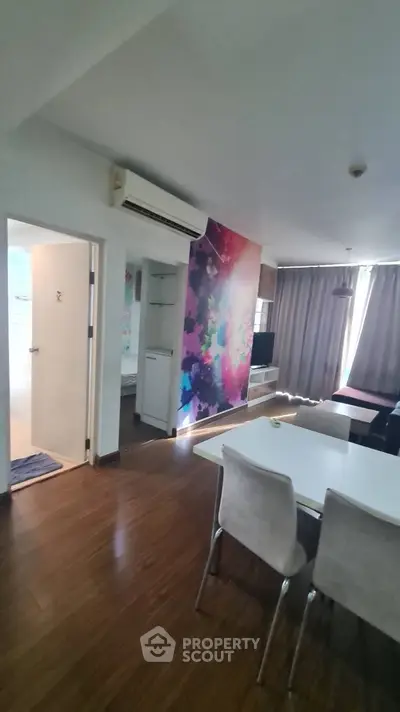 Modern apartment interior with colorful accent wall and dining area