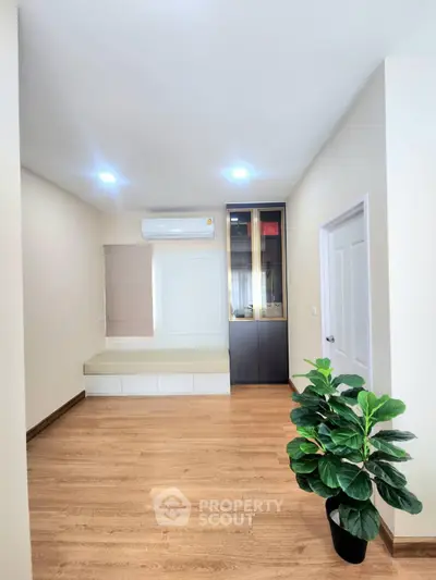 Spacious modern room with wooden flooring and elegant decor