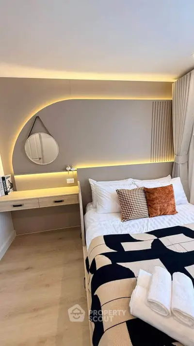 Modern bedroom with stylish lighting and cozy decor, featuring a comfortable bed and elegant design elements.