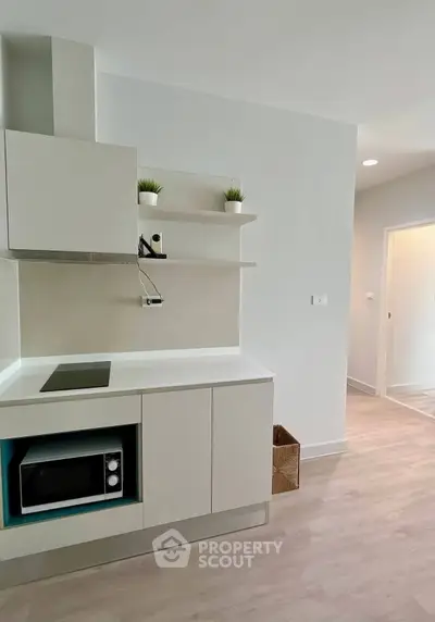 Modern minimalist kitchen with sleek cabinetry and built-in microwave