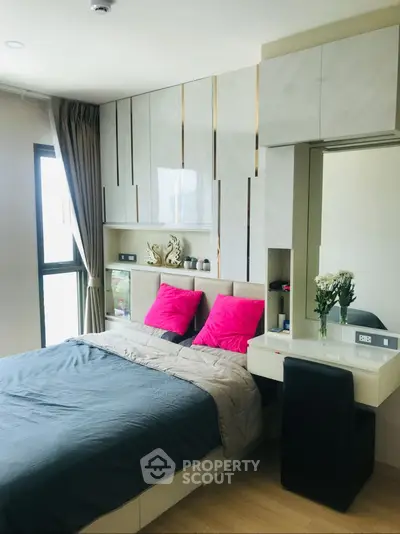 Modern bedroom with stylish decor and large window for natural light