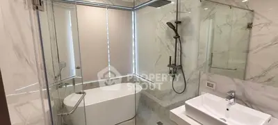 Luxurious modern bathroom with glass shower and freestanding bathtub