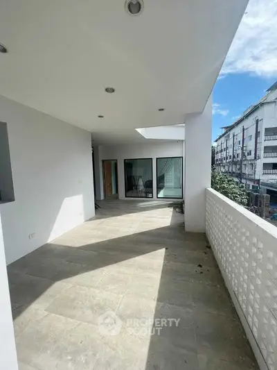 Spacious balcony with modern design and city view, perfect for relaxation and entertainment.