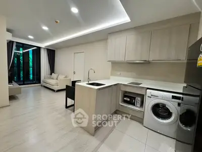 Modern open-layout kitchen with sleek appliances and spacious living area, perfect for contemporary living.