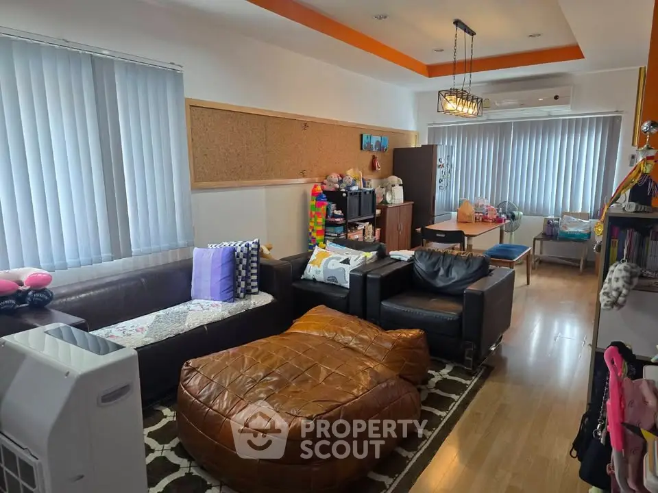 Spacious living room with modern decor and ample natural light