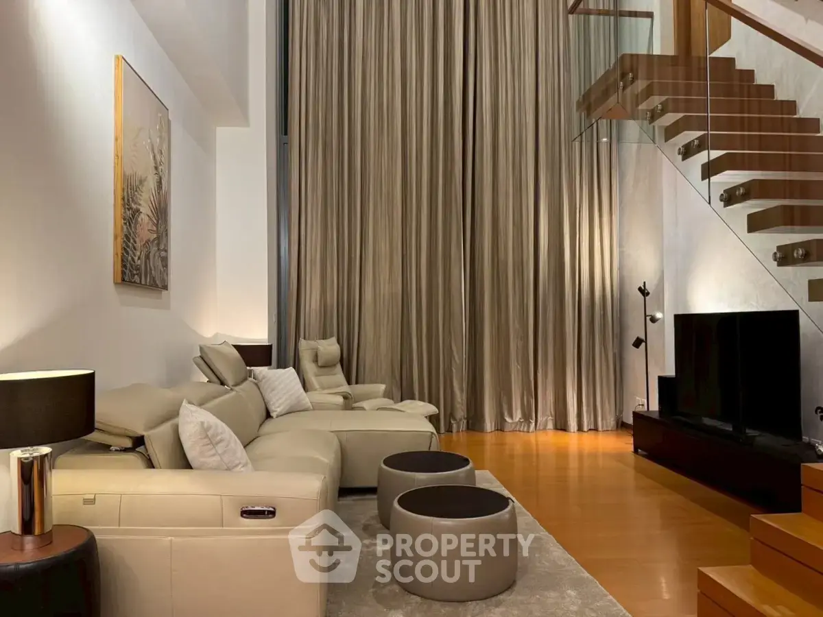 Luxurious modern living room with high ceilings and elegant staircase