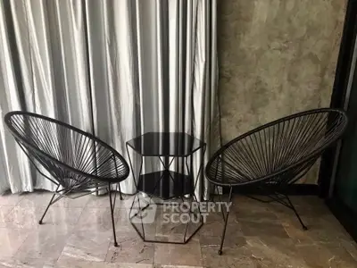 Stylish modern balcony with chic wire chairs and sleek side table